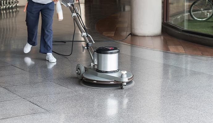 A professional cleaning a floor