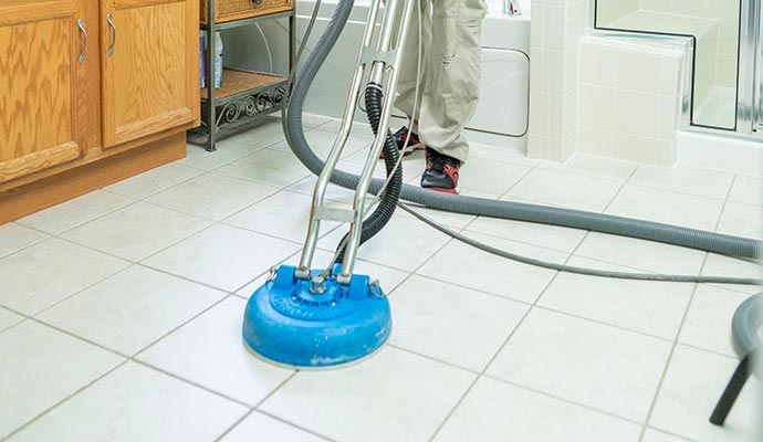 A professional cleaning a floor