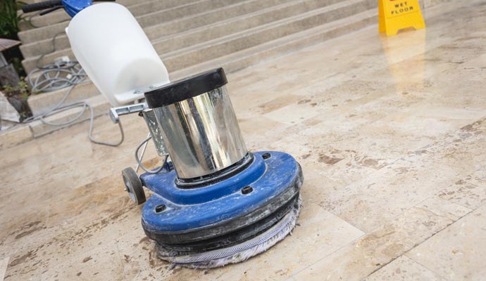 Commercial floor cleaning using equipment.